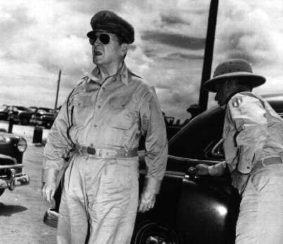 Manila, July 4, 1946. Gen. Douglas MacArthur stepping off his official car prior to ceremonies.